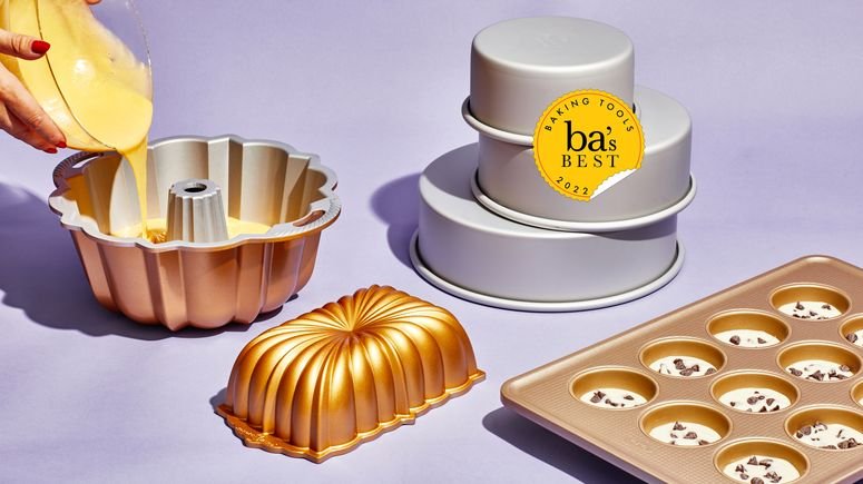 A few of the best baking pans—a Bundt pan, a loaf pan, a muffin tin, and round cake pans—on purple background